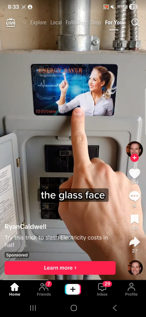 The Electrify Card product held by a hand, showing the text "Energy Saver Originol" printed on the front.